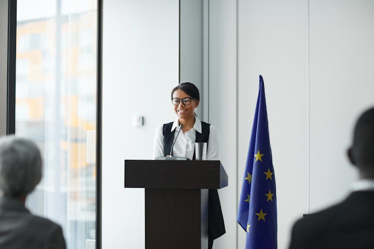 A Woman Near The Podium Having A Speech