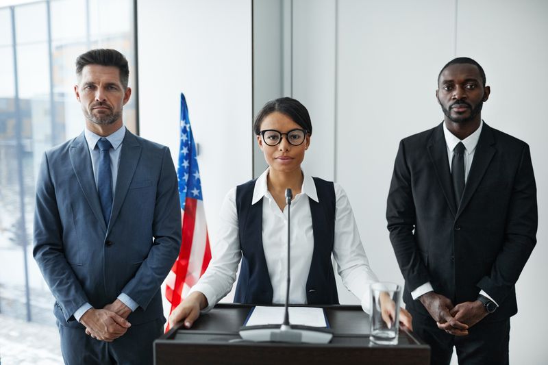 Official speaking at a press briefing — photo by Werner Pfennig on Pexels