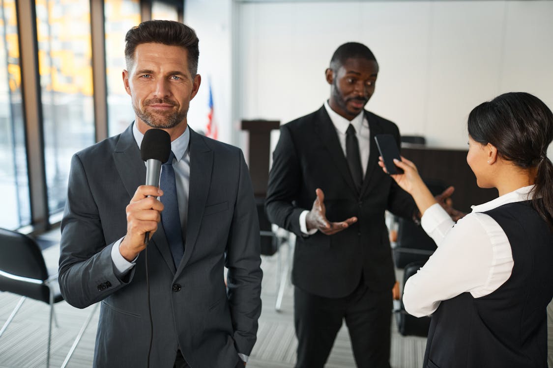 Free Man in Black Suit Holding Microphone Stock Photo