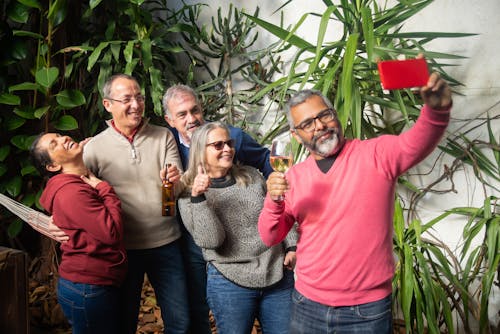 Group of People Standing Near Green Plant