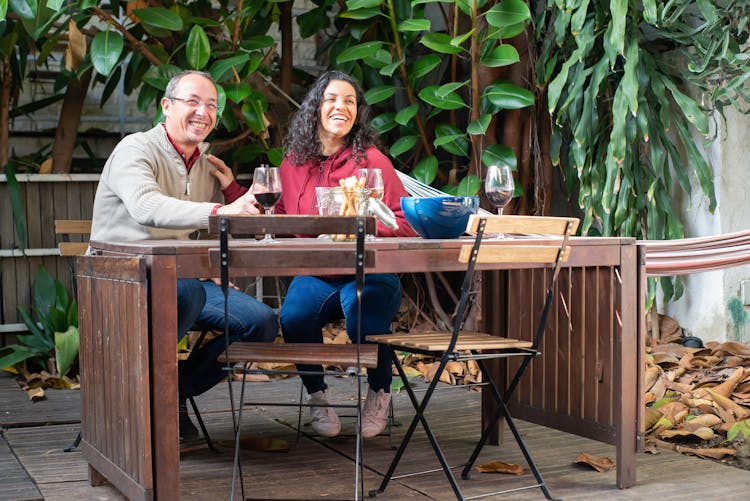 A Couple Having Wine In The Backyard