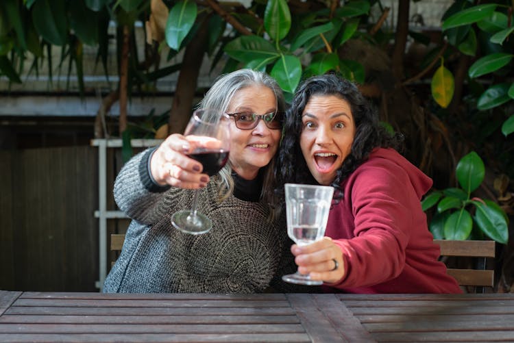 Two Happy Women Holding Drinks