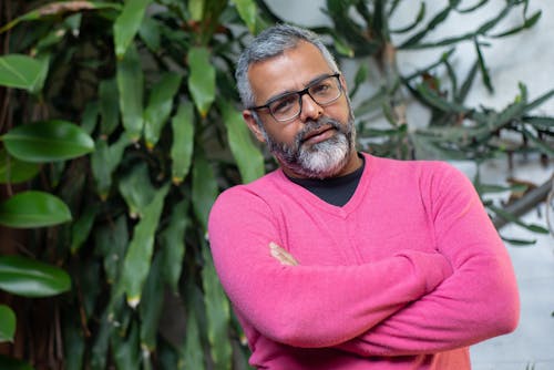 Man in Pink Sweater Wearing a Black Framed Eyeglasses