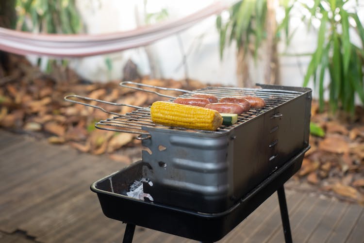 A Corn And Sausages On A Griller