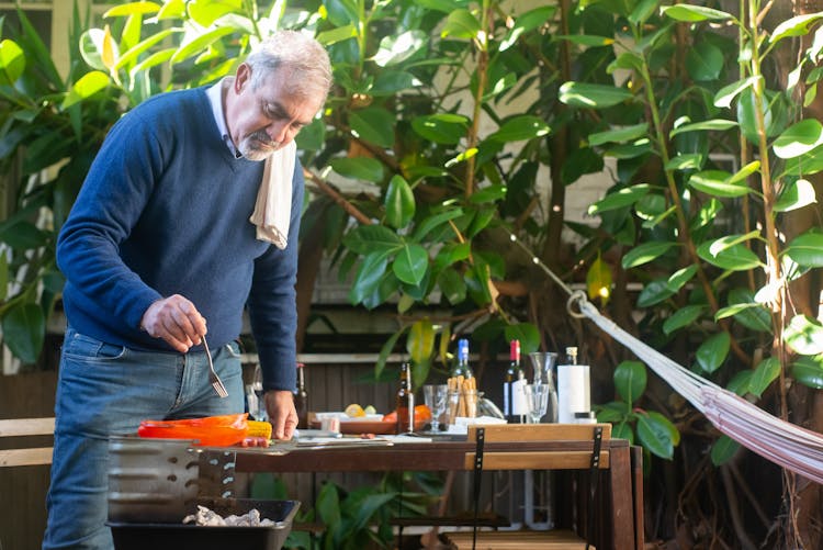 Elderly Man Grilling Barbeque