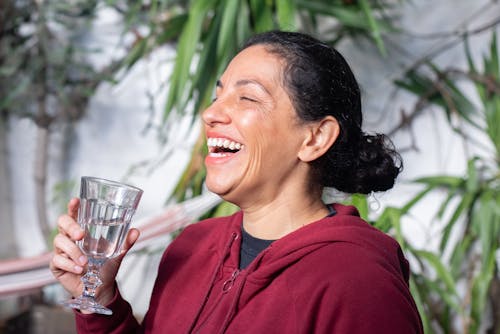 Free Photo of a Woman in a Red Hoodie Laughing Stock Photo