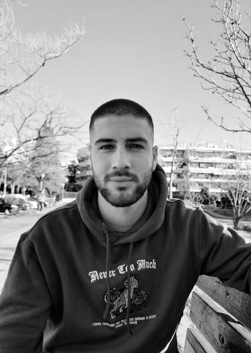 Grayscale Portrait of a Man Wearing a Hoodie