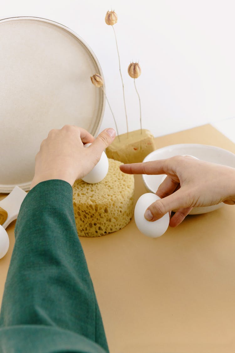 Woman Hands Holding Eggs Over Foam