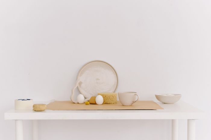 Ceramics and eggs on a pale table — photo by Ksenia Chernaya on Pexels