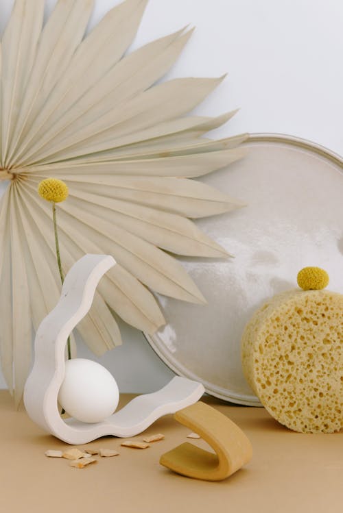 A White Egg on a White Wooden Vase with a Yellow Flower