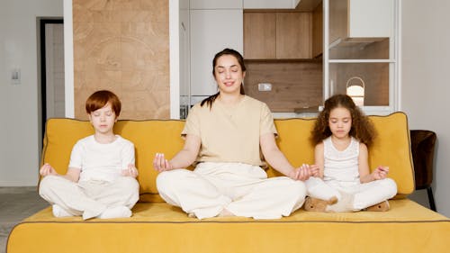 A Woman Meditating with Her Children