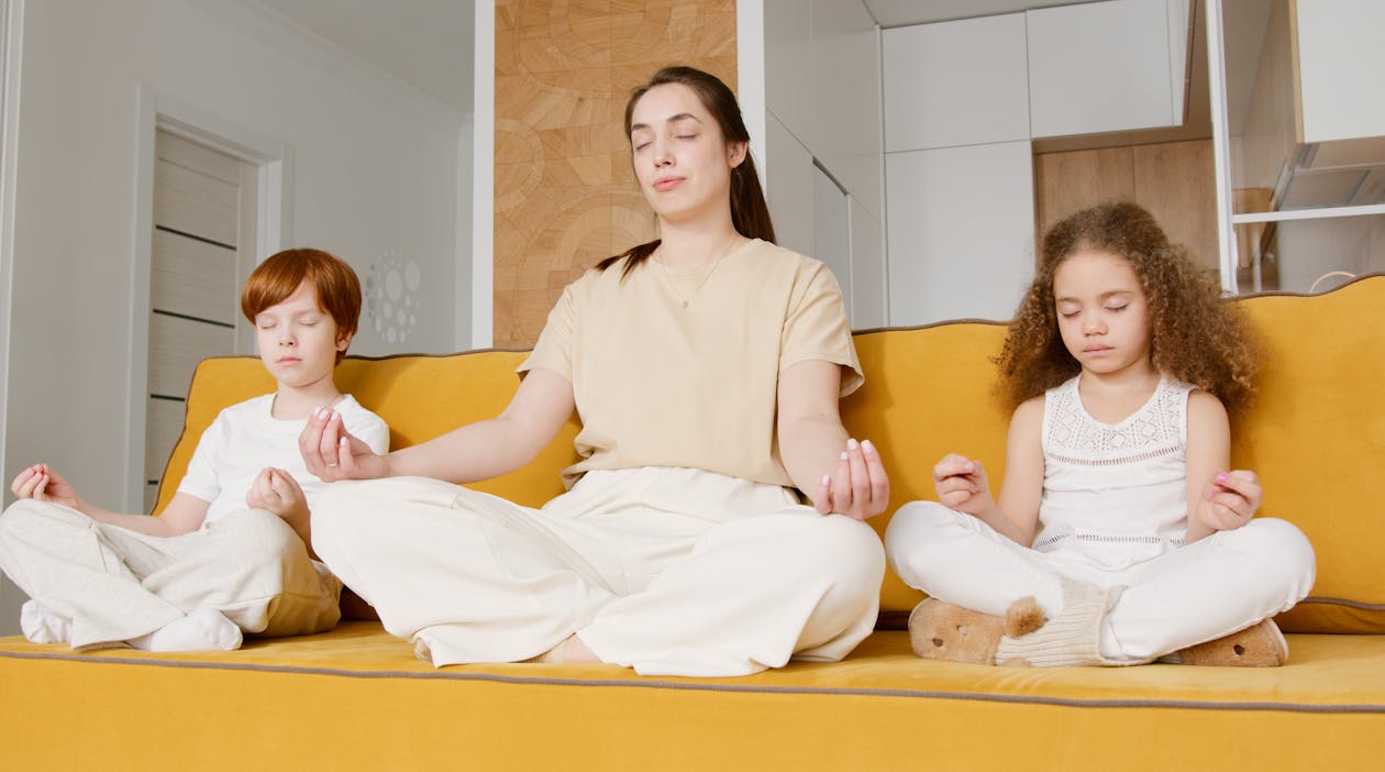 Free A Woman Meditating with Her Children Stock Photo