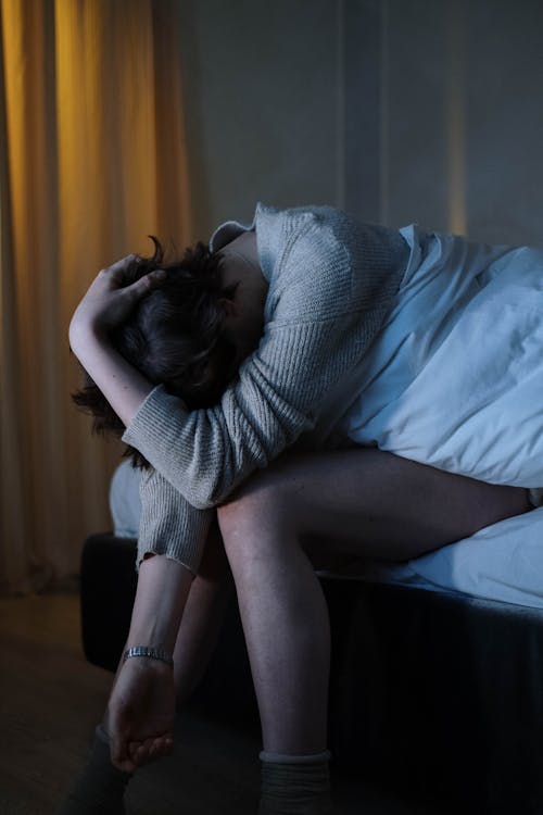 Free Photograph of a Person with Her Hand on Her Head Stock Photo