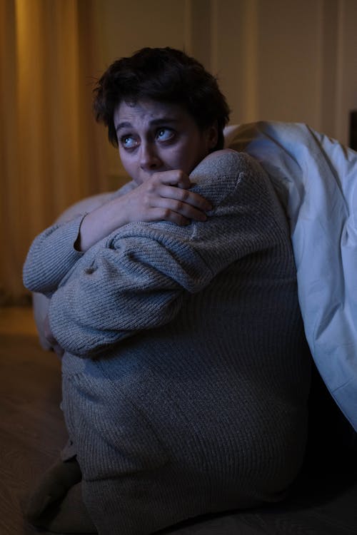 Free Photograph of a Woman Looking Up while Sitting on the Floor Stock Photo