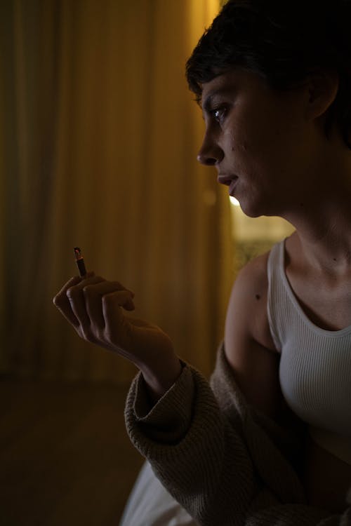 Free Close-Up Photo of a Woman with a Cigarette on Her Fingers Stock Photo