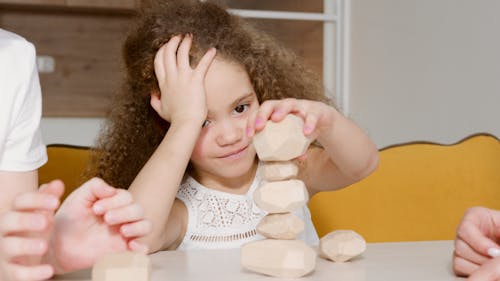 Free A Girl Stacking Pieces of Peeled Potatoes Stock Photo