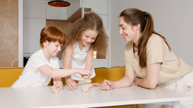 Happy family time with children stacking blocks at home.