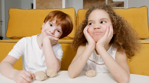 Free Photograph of Kids in White Tops with Their Hands on Their Cheeks Stock Photo