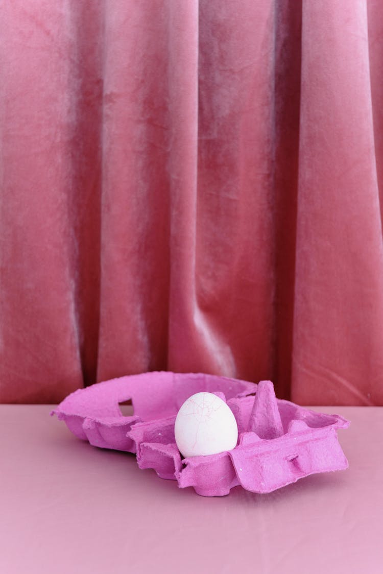 An Egg On A Pink Egg Tray