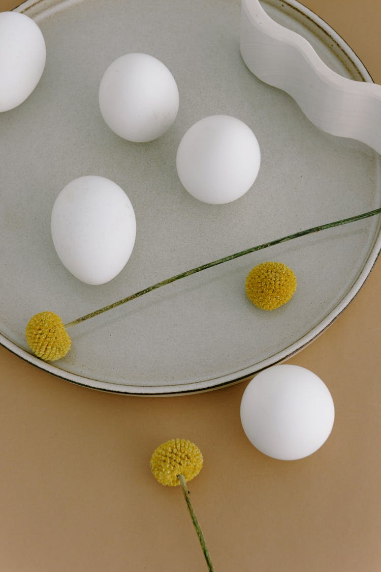 Flatlay Of Eggs And Objects On A Plate