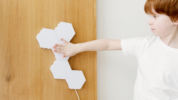 A Boy Holding Pentagon Shapes Papers
