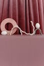 White Eggs on a Stand Beside a Curtain