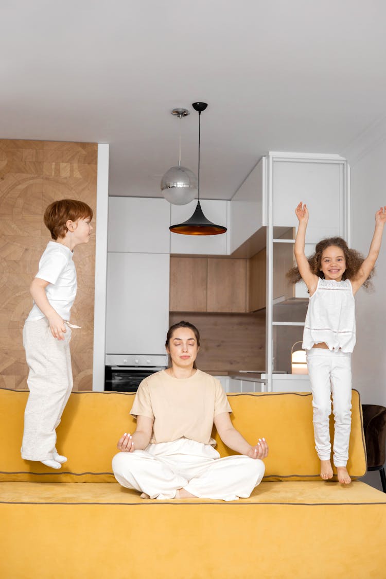 A Woman Doing Yoga While Sitting On The Sofa