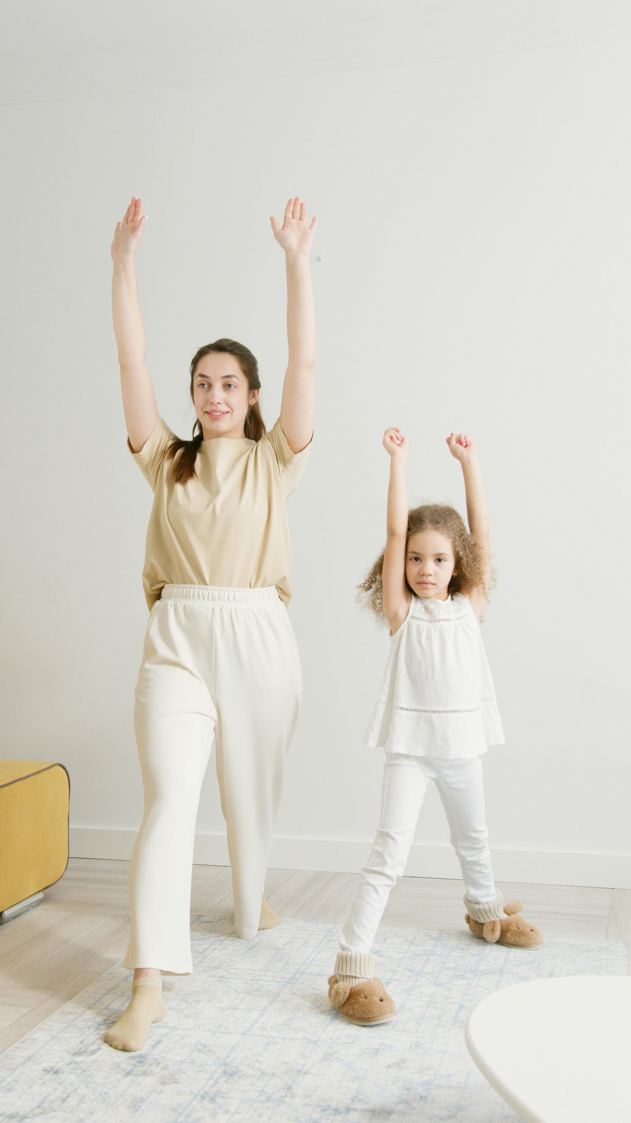 woman and a girl exercising at home