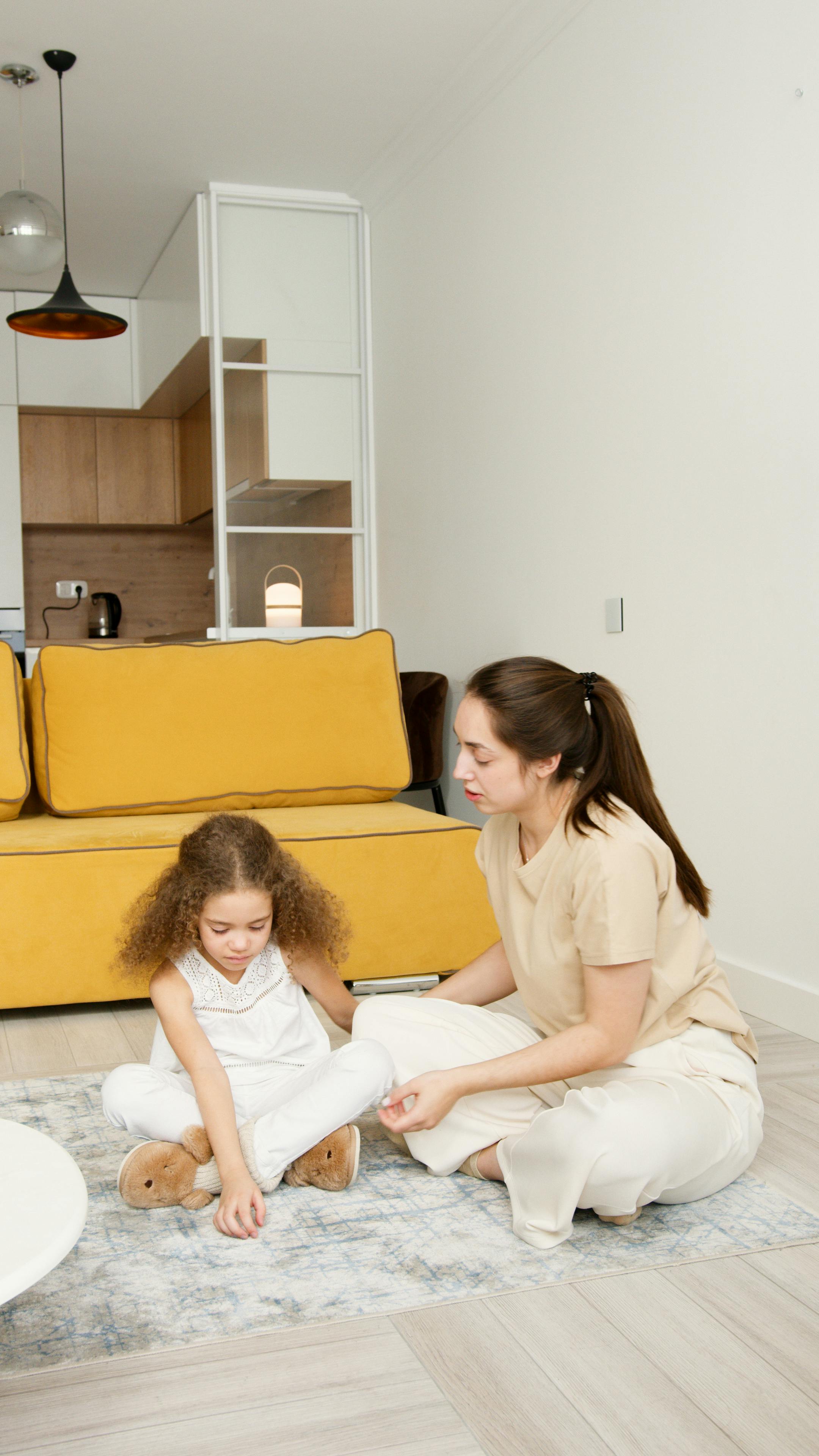 mother and daughter sitting on the floor