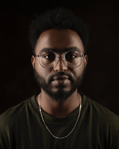 Portrait of a Man in a Black Crew Neck Shirt Looking at the Camera