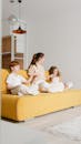 A Woman and Children Sitting on the Sofa
