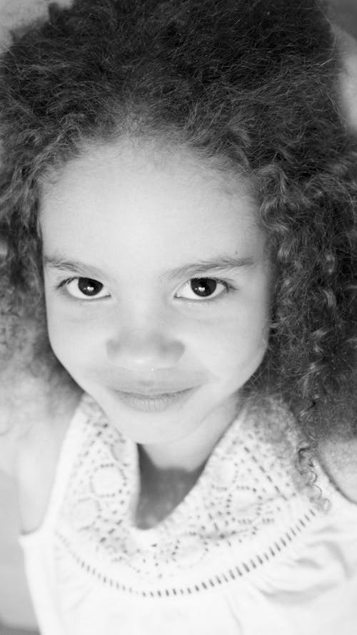 Grayscale Photo of a Young Girl