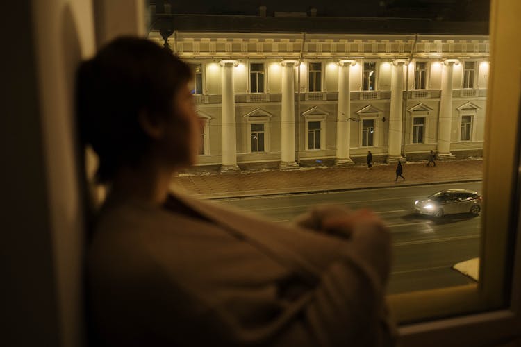 Sleepless Person Looking At Street In City At Night