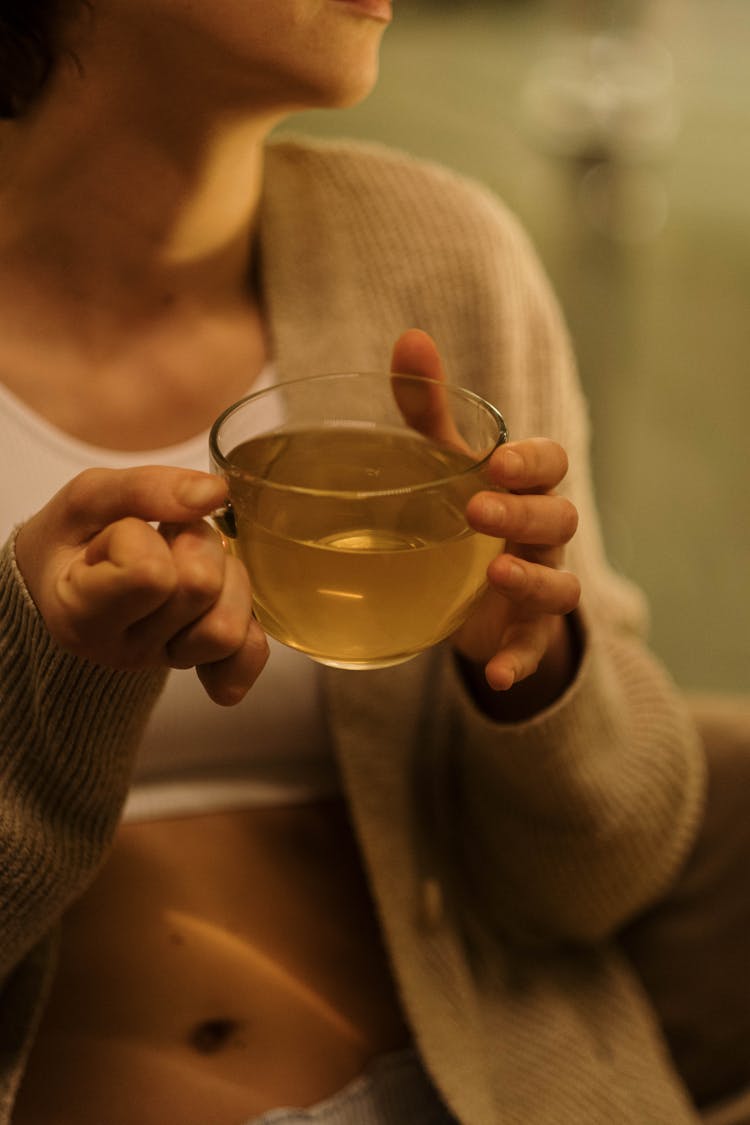 Person Holding A Cup Of Tea