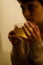 Woman in Gray Sweater Holding Clear Drinking Glass