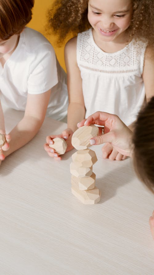 Children Playing with Balancing Wooden Blocks