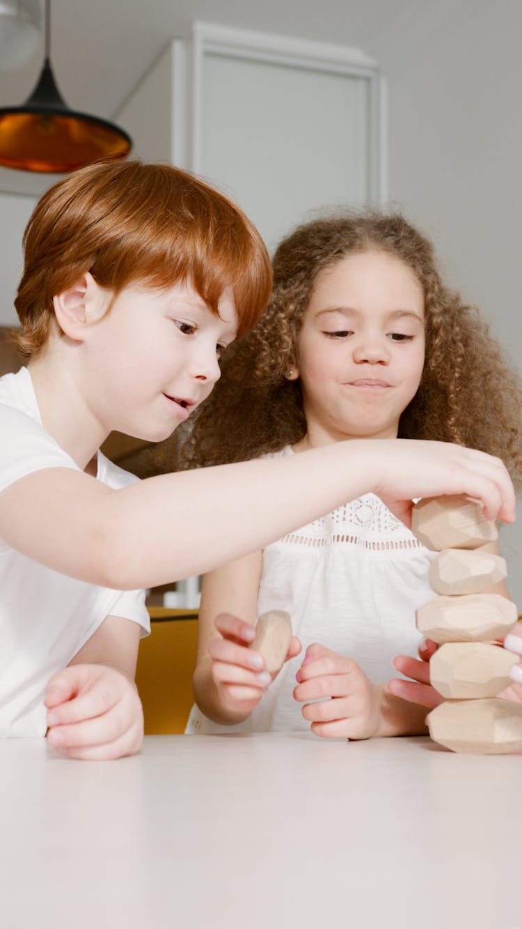 A Boy And Girl Playing Stones