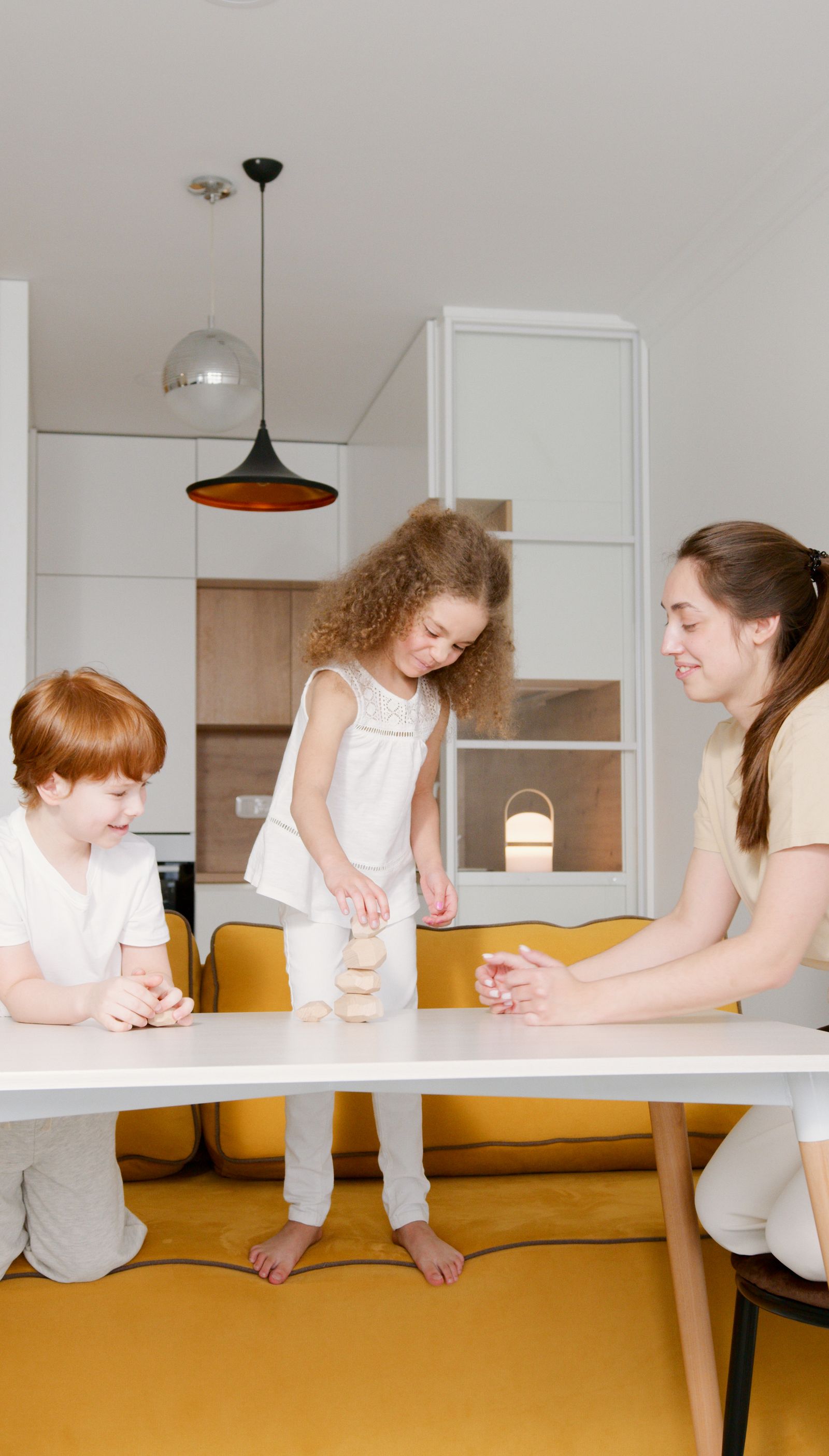 Child arranging bright wooden pieces during creative play