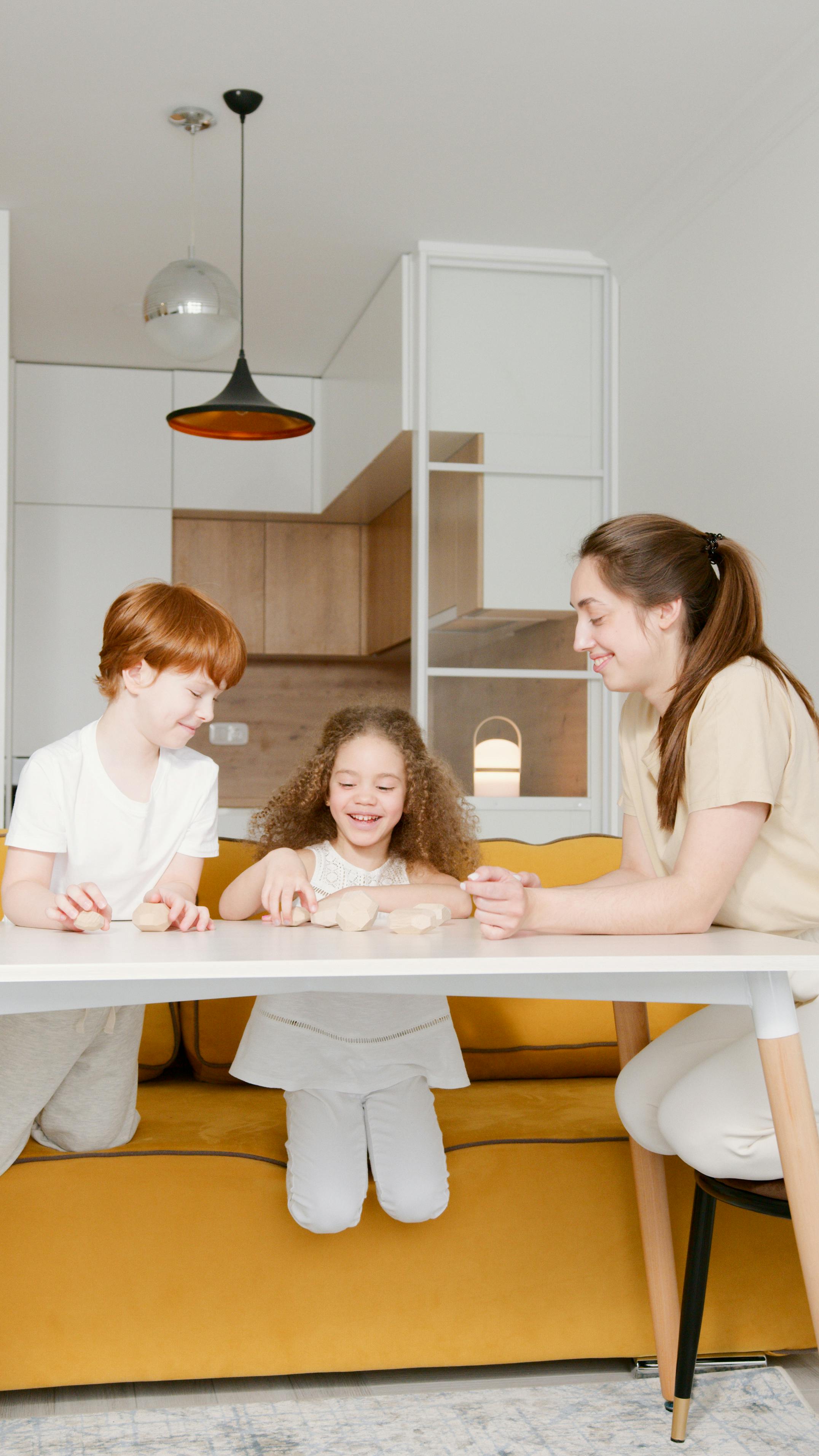 a woman and children sitting at a table