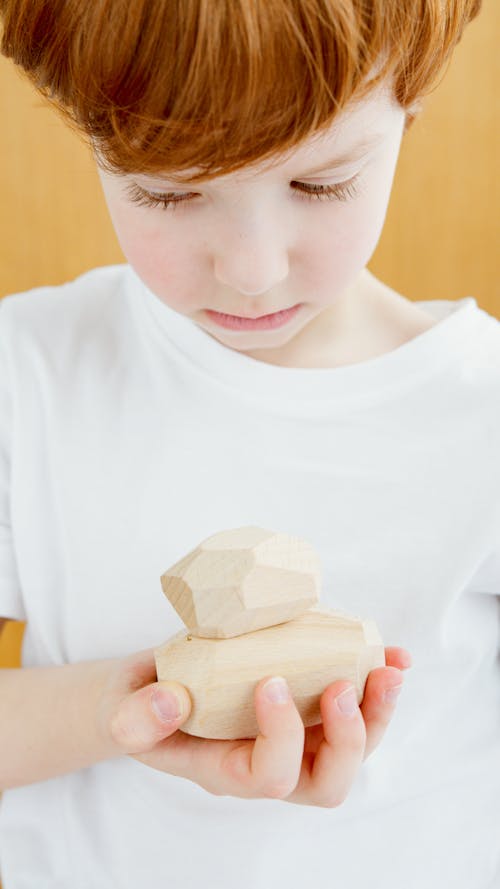 Boy Holding Wooden Blocks 