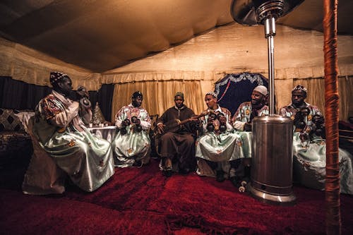 Group of ethnic men in traditional clothes with musical instruments