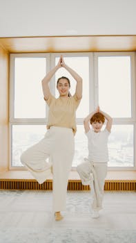 Mother and son practicing yoga indoors, promoting family fitness and healthy lifestyle.