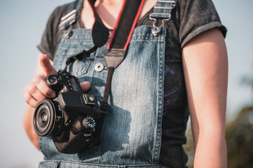 Woman Holding a DSLR Camera 