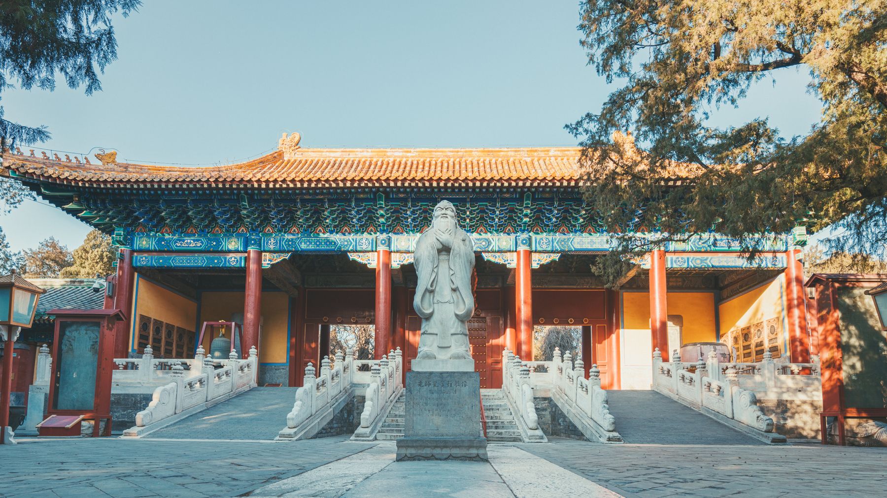 A picturesque view of a traditional Chinese temple with a prominent statue in Beijing, China.