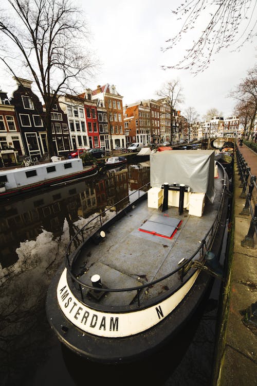 Moored ships on river in city