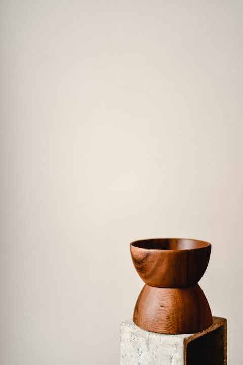 Turned wooden vessel resting on a stone plinth — photo by Eva Bronzini on Pexels