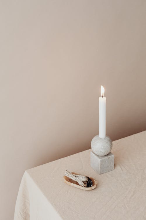 Burning Candle and an Incense on a Table 