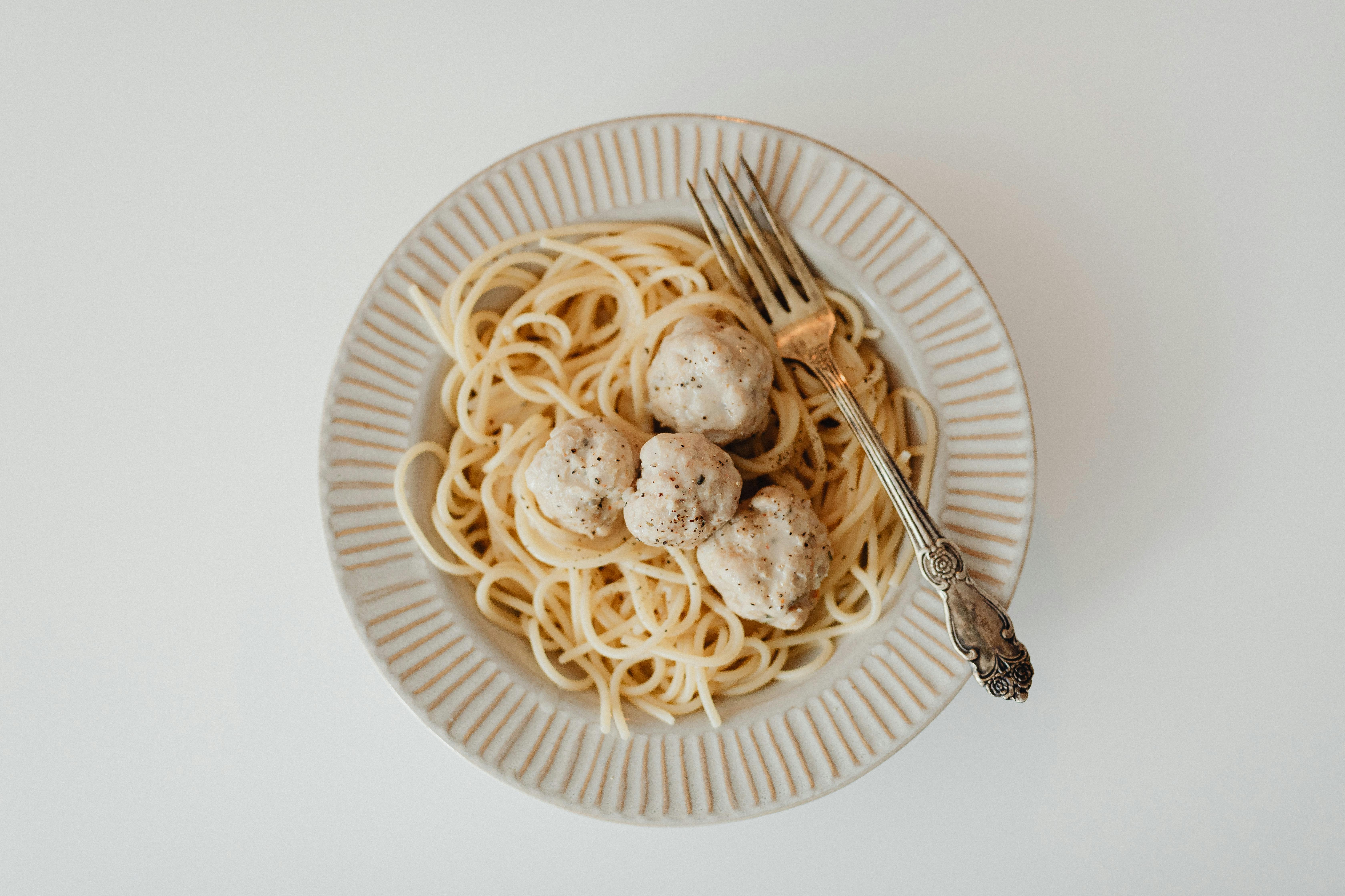 classic Italian-American dish like Chicken Vesuvio or a large plate of pasta from La Scarola - best italian food in chicago