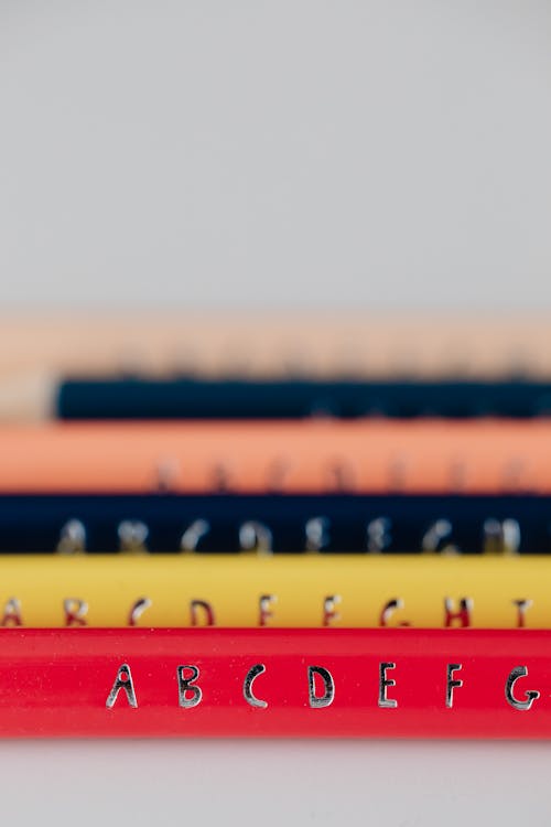 Selective Focus Photo of Silver Alphabet Stickers