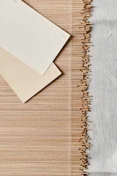 Top view of beige tone photo cards on a textured bamboo mat and linen surface. Minimalist design.. pexels, view, beige